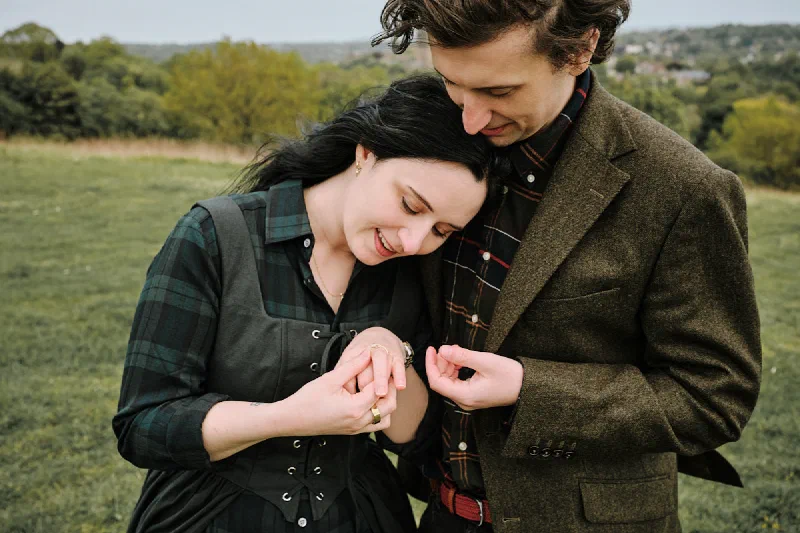The couple looking at the engagement ring after their Durham proposal