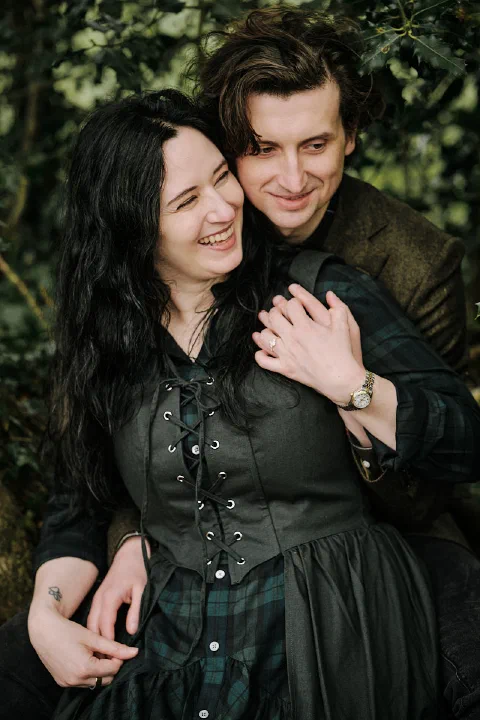 The newly engaged couple smiling together after their Durham proposal